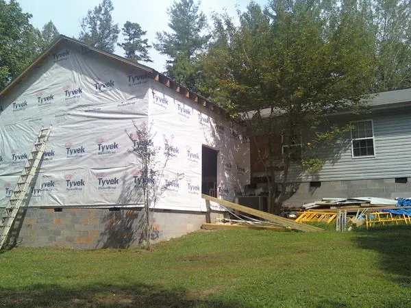 Tyvek wrapped gable on a new room addition beside an existing home in Granville